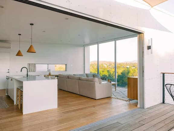 A modern light-filled home with views of the woods - Image 1